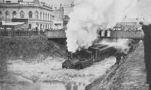 Flooded railway tracks with train passing under the bridge that crosses Chapel Street, near Arthur and Palermo Street.  25 January 1907.  Photo from the Stonnington History Centre’s online photo collection (Reg no. PH 491)