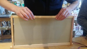 Rachel putting her honey frame together, that's real beeswax in there!
